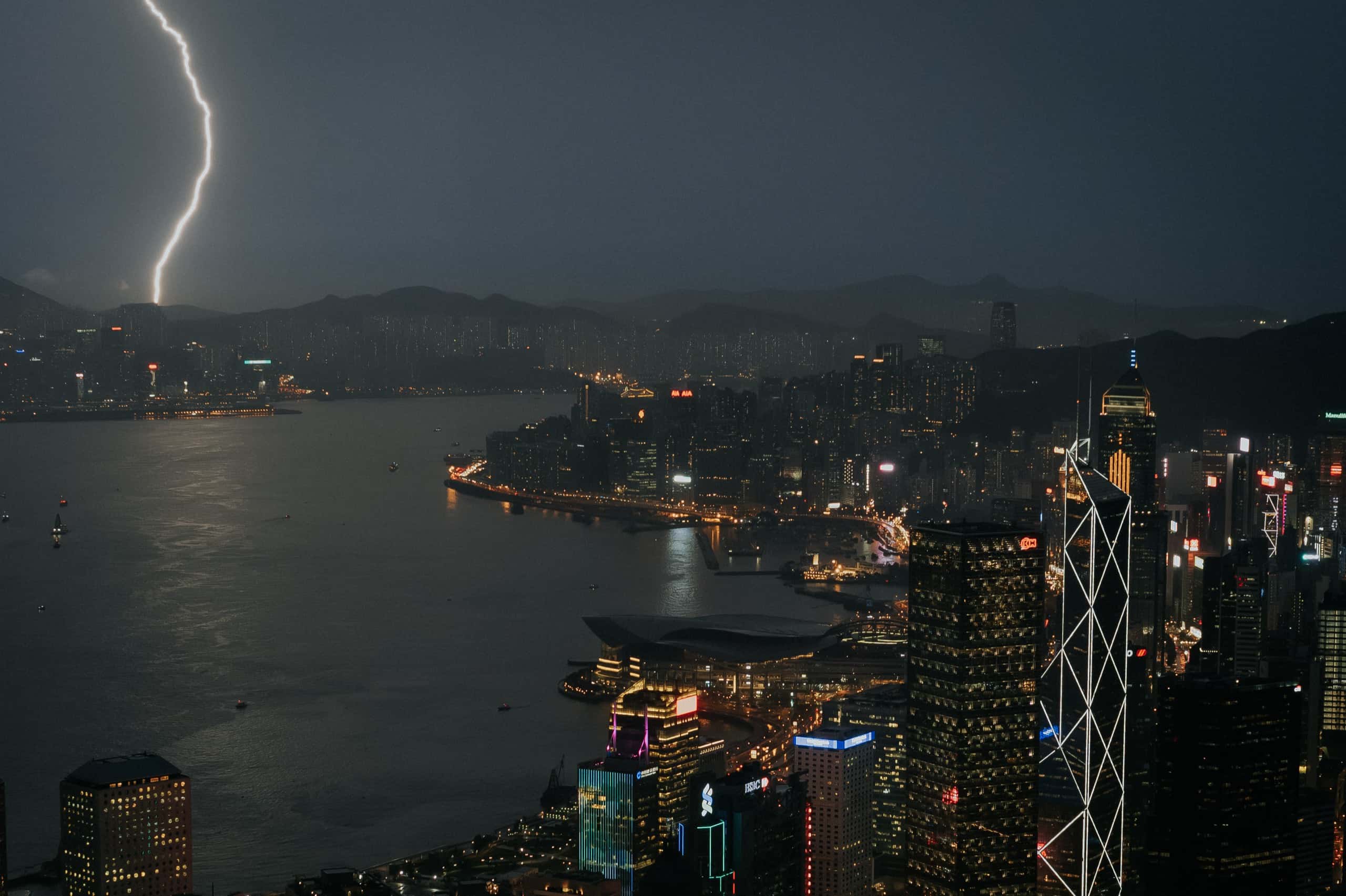 A bolt of lightning over Victoria Harbour, lighting up the Hong Kong business district at night